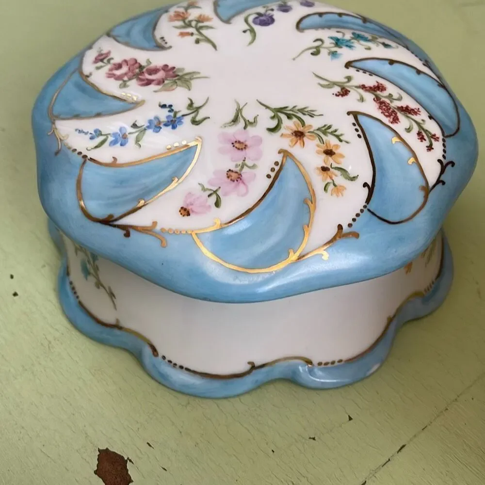 Vintage hand painted porcelain trinket box by Jeanette Wriedt .